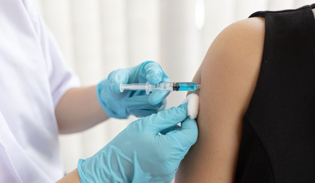image showing a person taking a vaccine