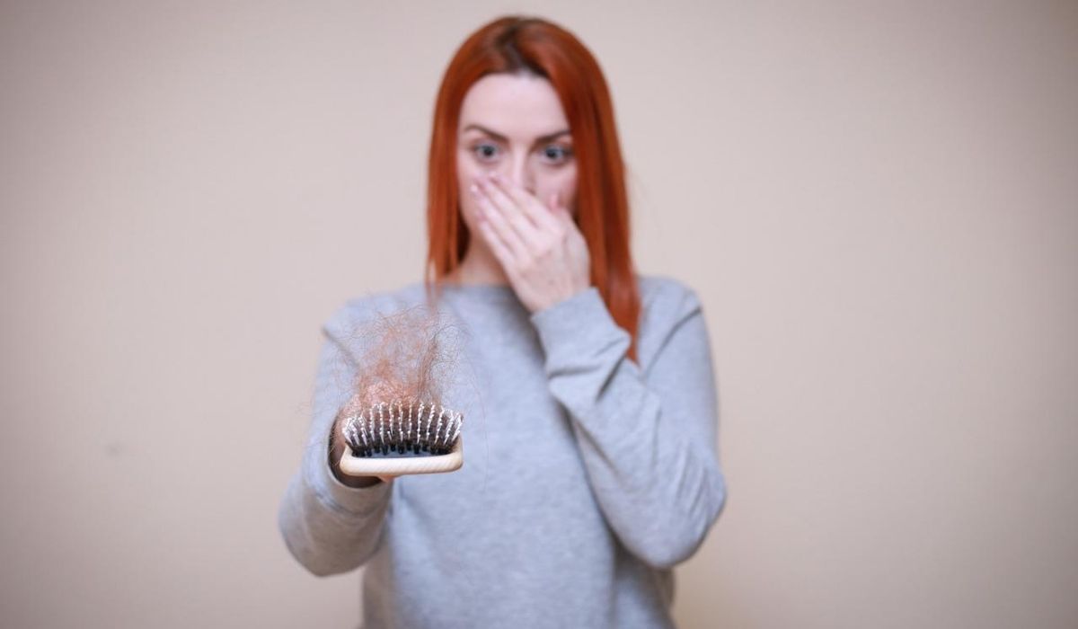 Image showing women holding comb with lost hair